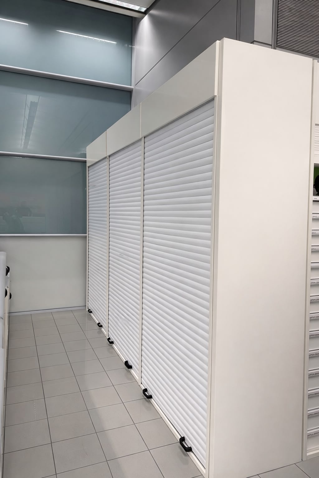 White internal roller shutters fitted for secure storage
