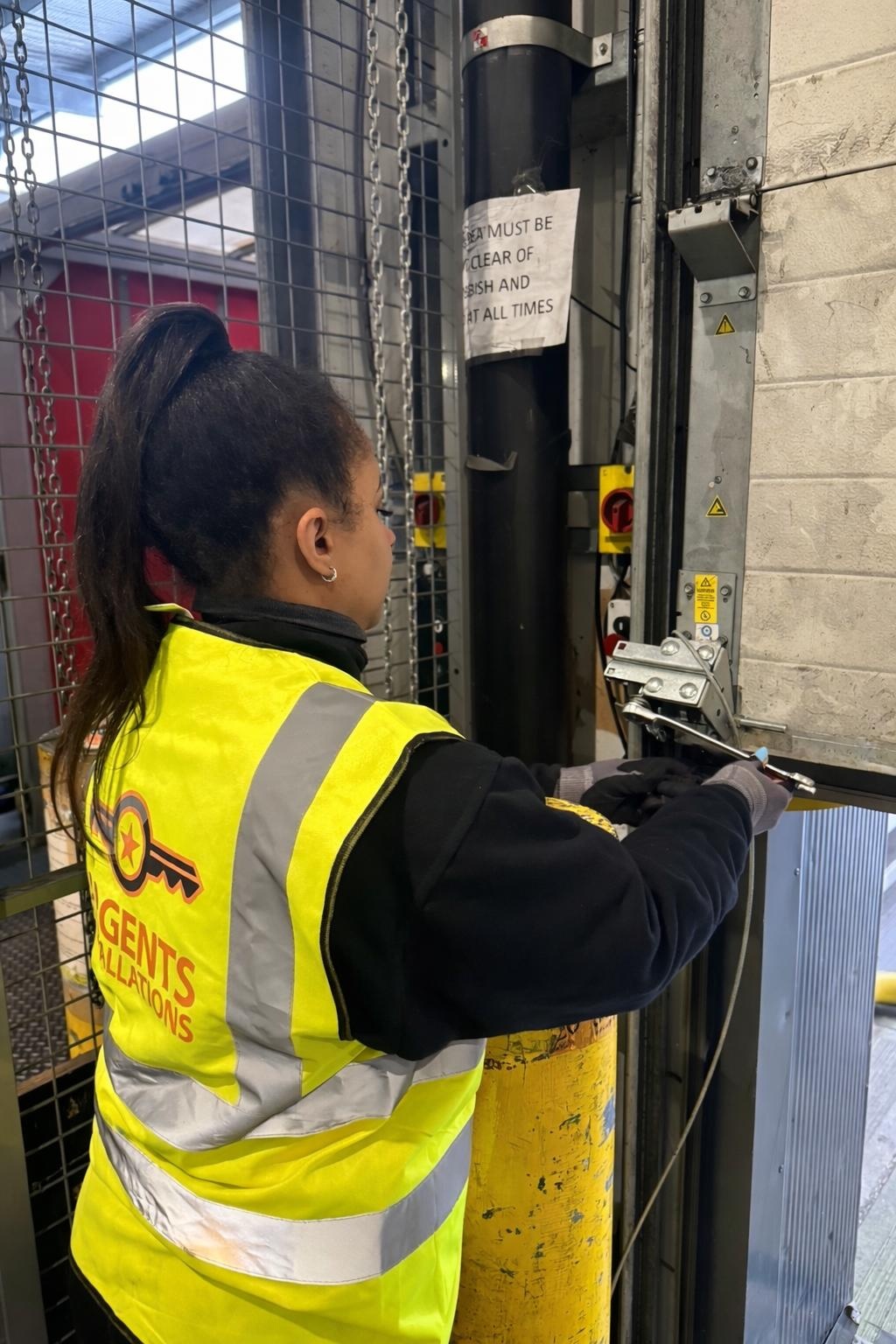 Argents Installations engineer servicing an industrial door mechanism